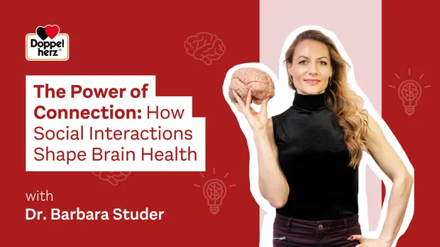 Imagen con fondo rojo que presenta a la Dra. Barbara Studer, quien sostiene un cerebro artificial. A la izquierda, se encuentra el texto "El poder de la conexión: cómo las interacciones sociales afectan la salud cerebral". Se retrata la importancia de las relaciones sociales en el bienestar mental.