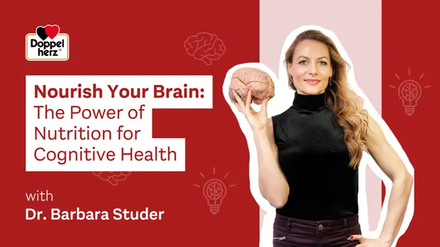 Mujer sosteniendo un modelo de cerebro con una mano, sonriendo. El texto destaca el poder de la nutrición para la salud cognitiva, titulado "Nourish Your Brain". Se menciona a la Dra. Barbara Studer como presentadora, con un fondo en tonos rojos y gráficos relacionados con el cerebro.